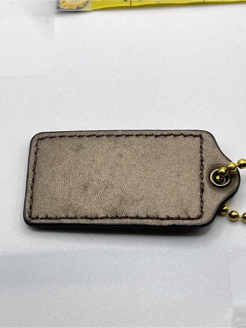 COACH Iridescent Brown Leather Hang Tag with Gold Chain